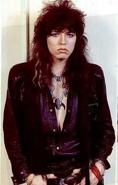 a man with long hair wearing a leather jacket