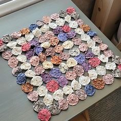 there is a table that has many different flowers on it, and the colors are multicolored