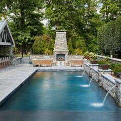 a pool with a fire place in the middle