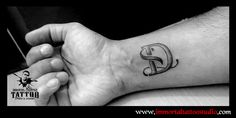 a person with a small tattoo on their wrist holding the hand of another person's arm