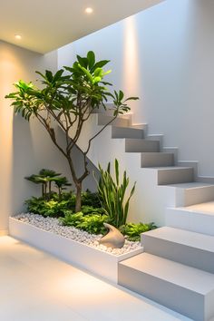 an indoor planter with plants and rocks in the center is next to some stairs