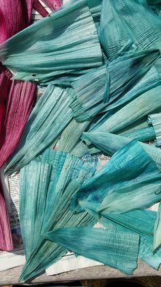 several pieces of art that are made out of paper and colored in blue, pink, green