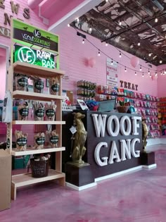 there is a store with pink walls and flooring in the shop, it has a sign that says woof gang