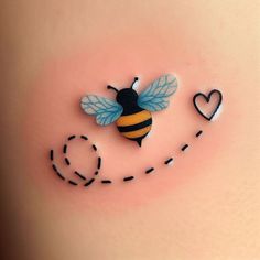 a close up of a bee on the side of a woman's stomach with hearts