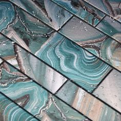 blue and green marble tiles with water droplets on them, as well as the floor