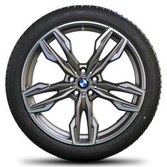 the front wheel of a car with chrome spokes and blue brake pads on white background