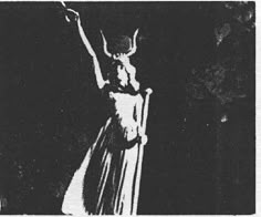 a black and white photo of a woman in a long dress with her arms up