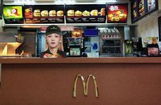 a mcdonald's restaurant counter with a woman behind the counter