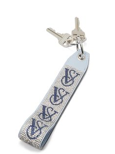 a keychain with the initials on it and a chain hanging from it's side