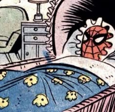 the spider man is sleeping in his bed