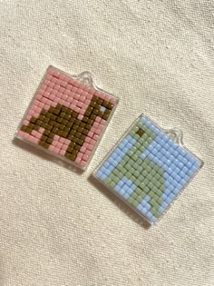two pieces of bead art on a white surface