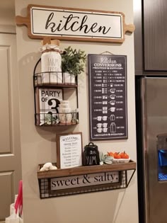 a kitchen with a refrigerator and some signs on the wall