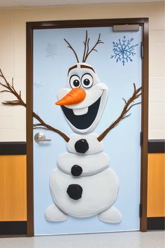 the door is decorated to look like a snowman with an orange carrot in his mouth