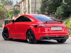 a red car is parked on the street