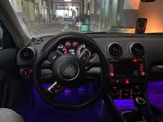 the interior of a car with red and blue lights