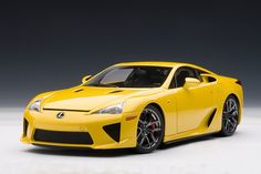 a yellow sports car on a white surface