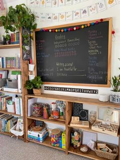 a chalkboard with writing on it in front of a bookshelf filled with children's toys