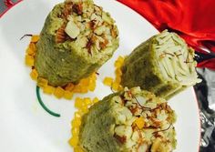 there are three rolls on the plate with nuts and other toppings around each one