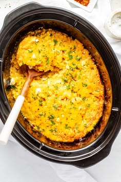 a crock pot filled with an omelet on top of a white table