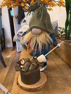 a stuffed animal sitting on top of a wooden table next to a potted plant