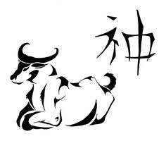 an animal that is laying down with chinese writing on the wall in the back ground