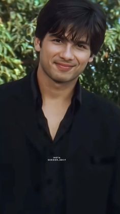 a young man is smiling for the camera