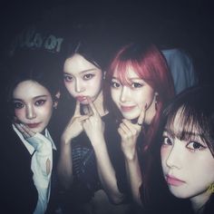 four girls posing for the camera with their hands together