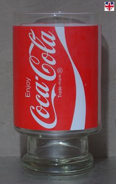 a glass cup with a coca - cola logo on it