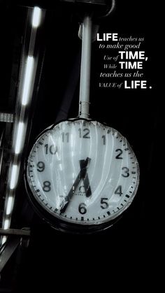 a clock hanging from the side of a building with a quote above it that reads, life is not about time