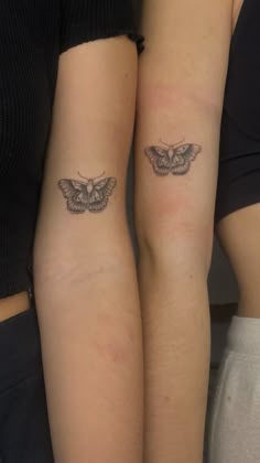 two people with matching tattoos on their arms