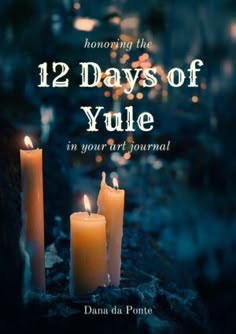 two candles sitting next to each other with the words 12 days of yule on them