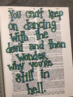 an open book with the words you can't keep on dancing with the devil and then wonder why you're still in hell