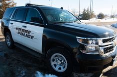a police vehicle is parked in the snow