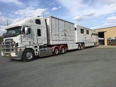 a large semi truck parked in front of a building