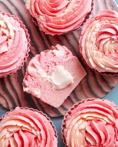 cupcakes with pink frosting on a plate