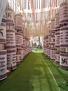 A beautiful wedding entrance decorated with Sanskrit shloka scrolls, sacred Swastik symbols, and hanging floral garlands, creating a divine and traditional ambiance for the celebration.