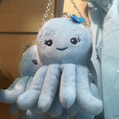an octopus stuffed animal hanging from a chain