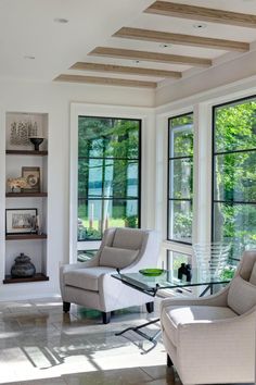 a living room filled with furniture and windows