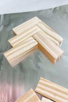 several pieces of wood sitting on top of aluminum foil