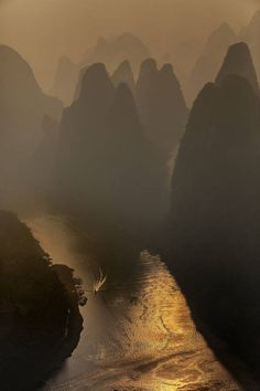 an aerial view of the river and mountains in china at sunrise or sunset, as seen from above