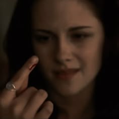 a woman holding a ring in her right hand