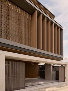 an empty parking lot next to a building with wooden slats on the front and side