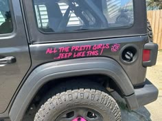 a jeep with pink stickers on it's side