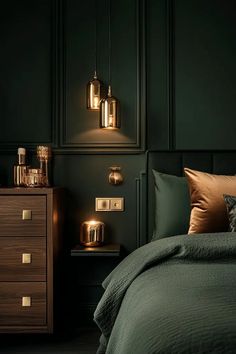 a bedroom with dark green walls and gold accents on the bed, nightstands and lamps