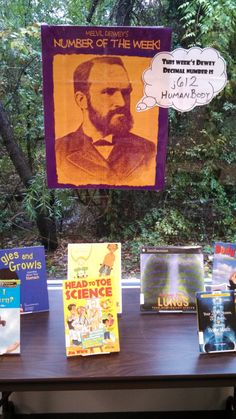 there are many books on the table and one has a sign that says number of the week