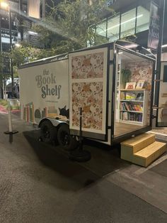 the book shelf trailer is parked on the side of the street