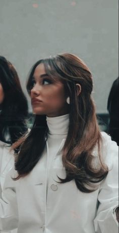 two women sitting next to each other in front of a mirror with their hands on their hips