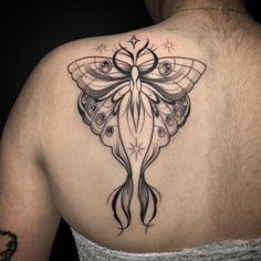 a woman with a butterfly tattoo on her back