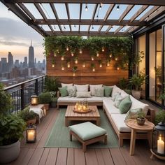 an outdoor living area with couches, coffee table and candles on the patio deck