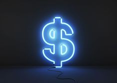 a neon blue dollar sign sitting on top of a table